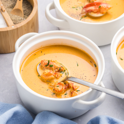 angled shot of spoon in bowl of lobster bisque