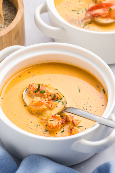 angled shot of spoon in bowl of lobster bisque