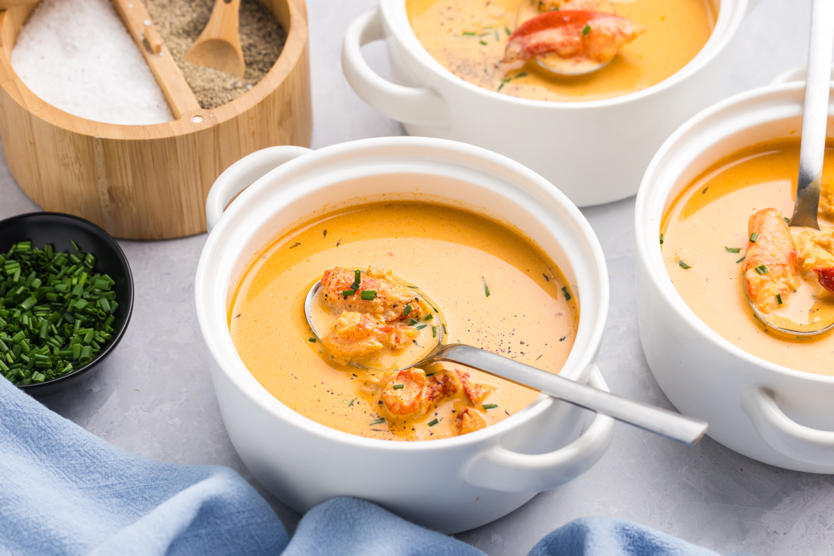 angled shot of spoon in bowl of lobster bisque