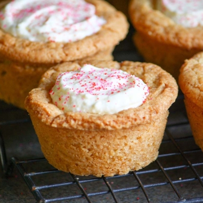 angled shot of raspberry cheesecake cookie cups on cooling rack