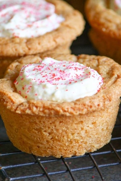 angled shot of raspberry cheesecake cookie cups on cooling rack