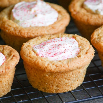 angled shot of raspberry cheesecake cookie cups on wire rack