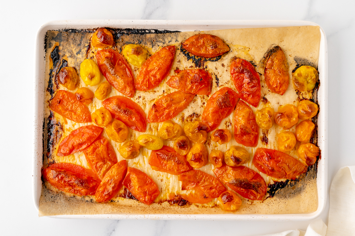 overhead shot of tomatoes cooked on baking sheet