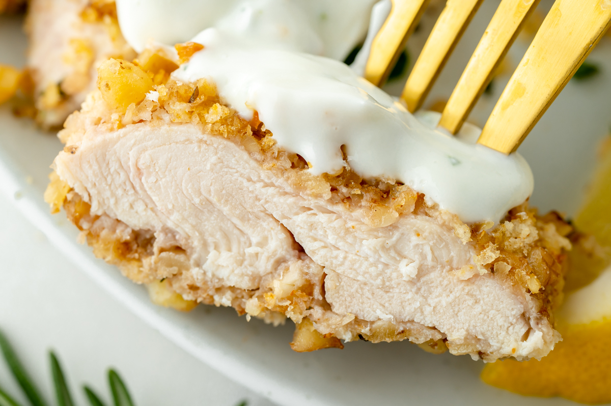 close up of bite of walnut crusted chicken on fork