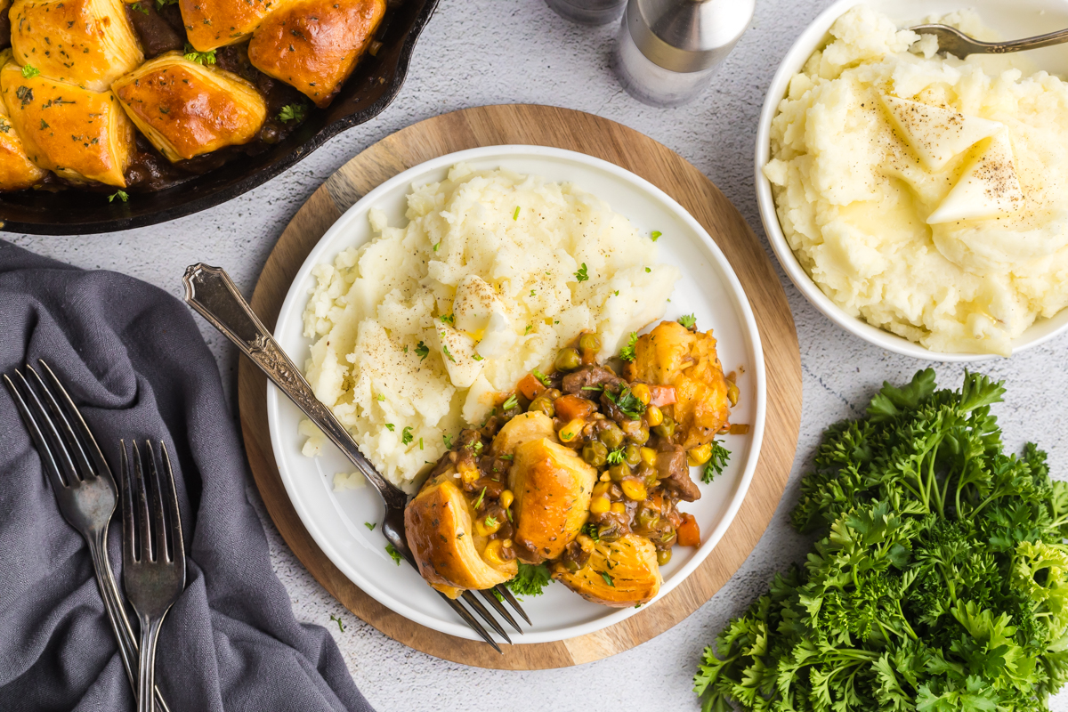 overhead shot of beef pot pie on plate with mashed potatoes