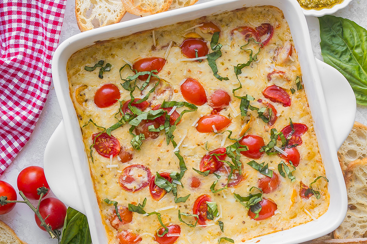 overhead shot of baked caprese dip in baking dish