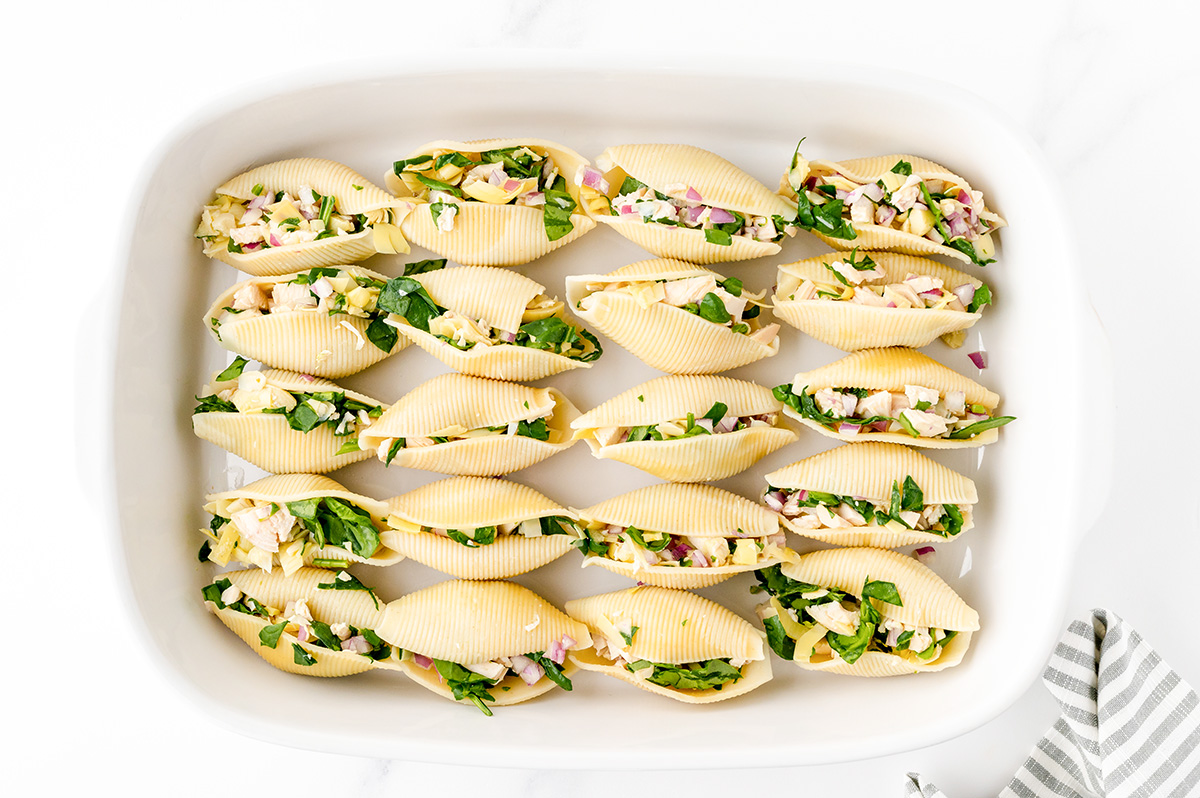 overhead shot of shells stuffed with chicken in baking dish