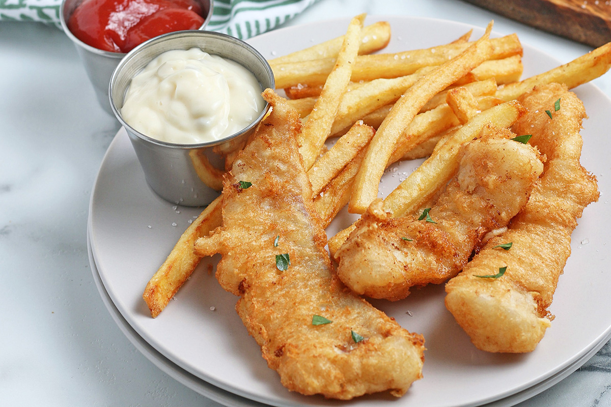 fried fish on plate with fries and tartar sauce