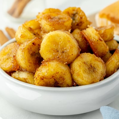 angled shot of bowl of fried bananas