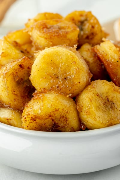 angled shot of bowl of fried bananas