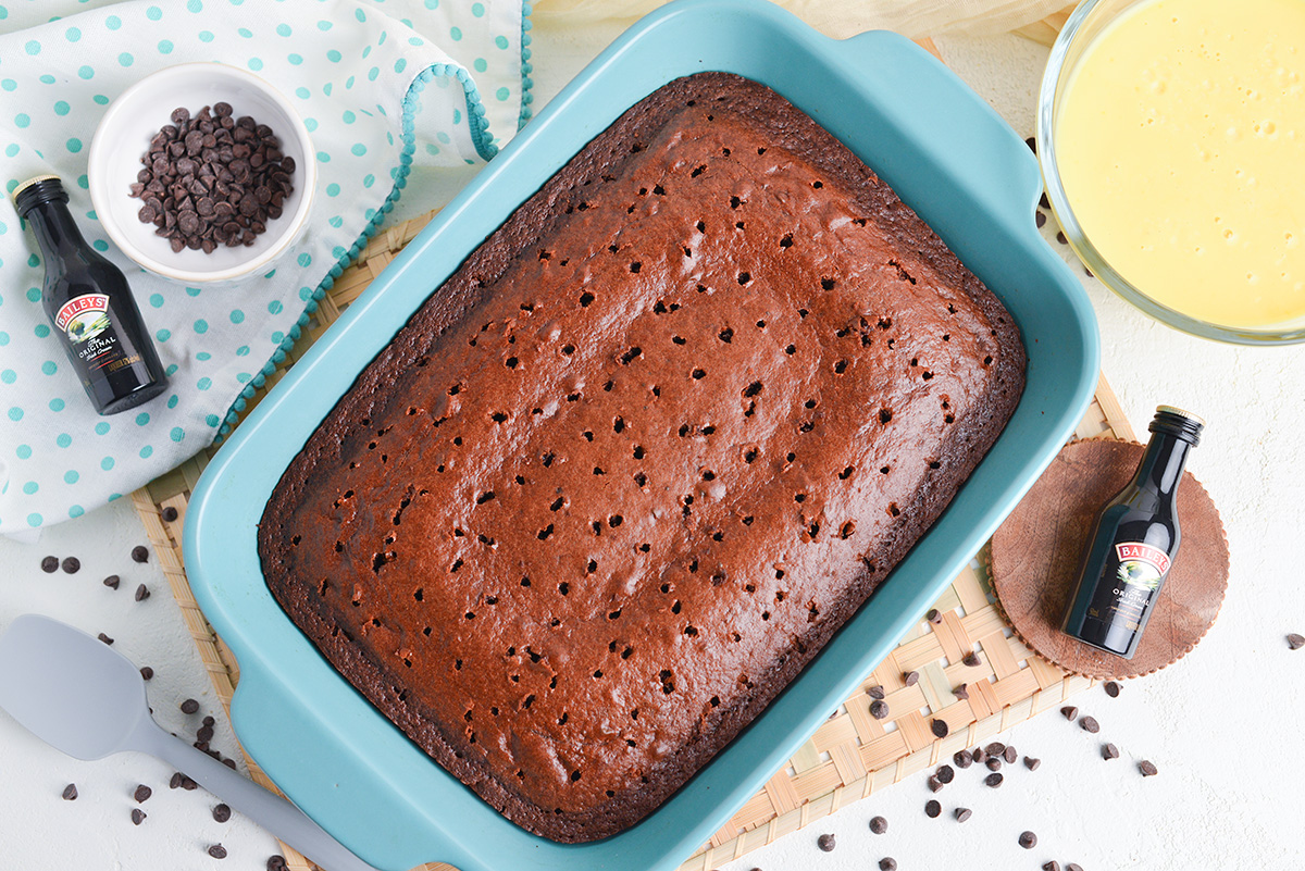 overhead shot of chocolate cake with holes poked in it