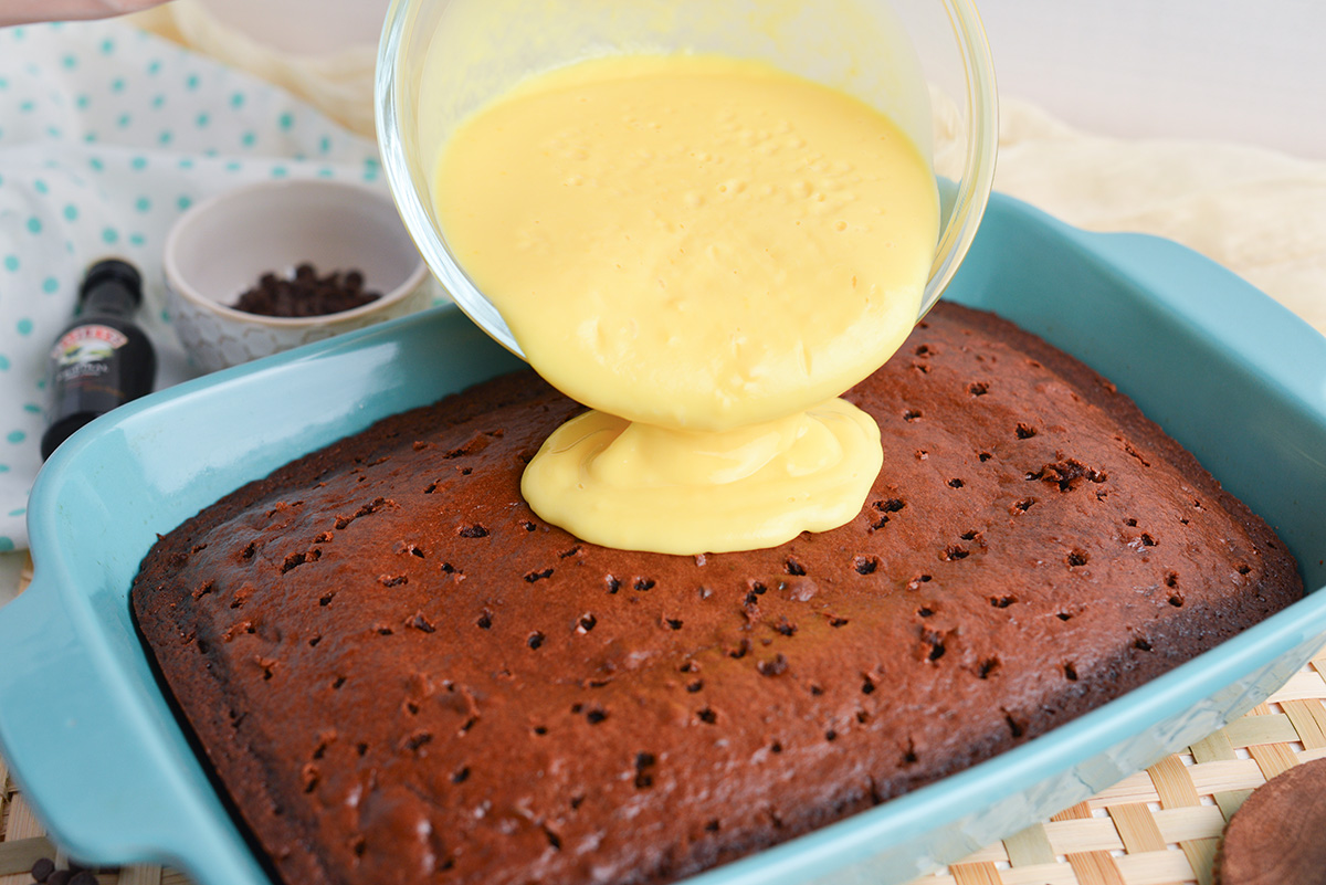 overhead shot of irish cream pudding poured over cake