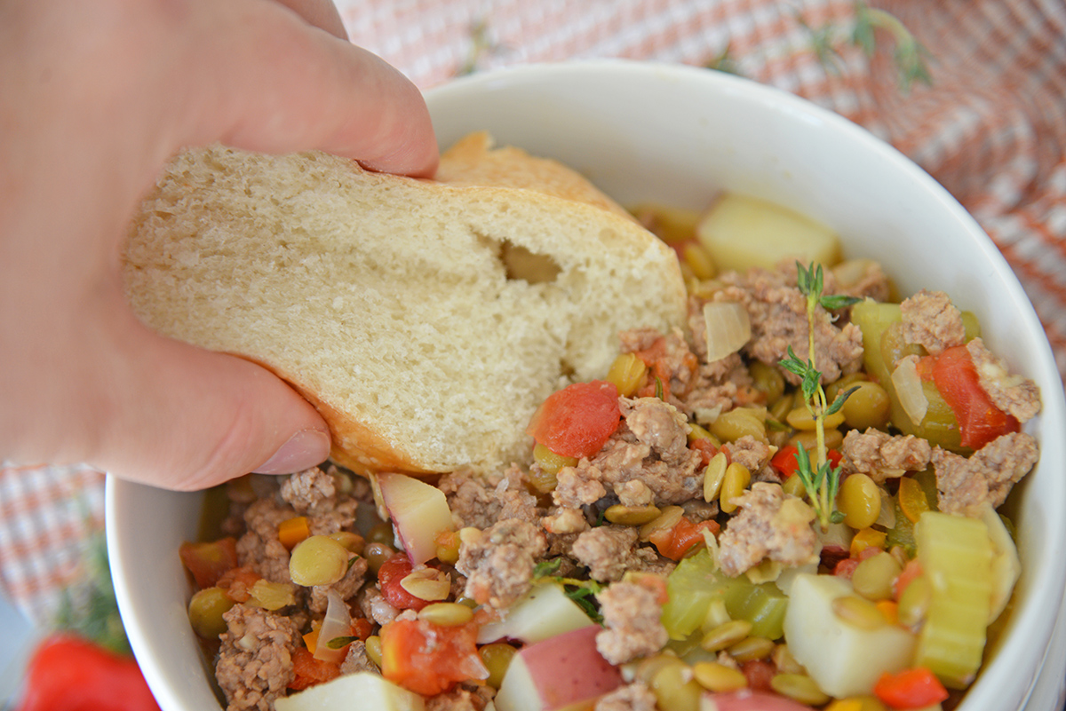 bread dipping into owl of stew