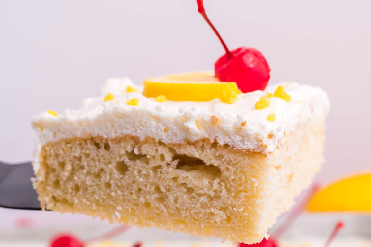 straight on shot of slice of lemon sheet cake on spatula