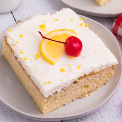 angled shot of slice of lemon sheet cake on plate