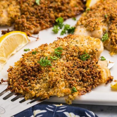 close up angled shot of breaded tilapia on tray