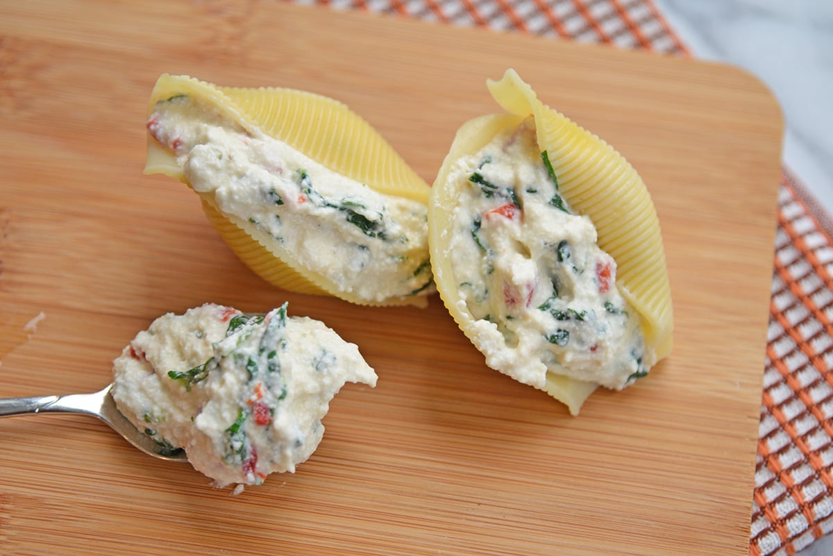 close up of two pasta shells filled with ricotta filling