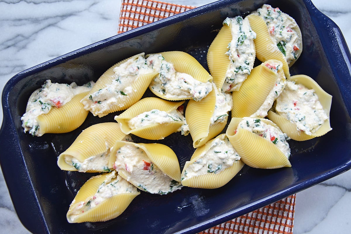 overhead shot of filled shells in blue baking dish