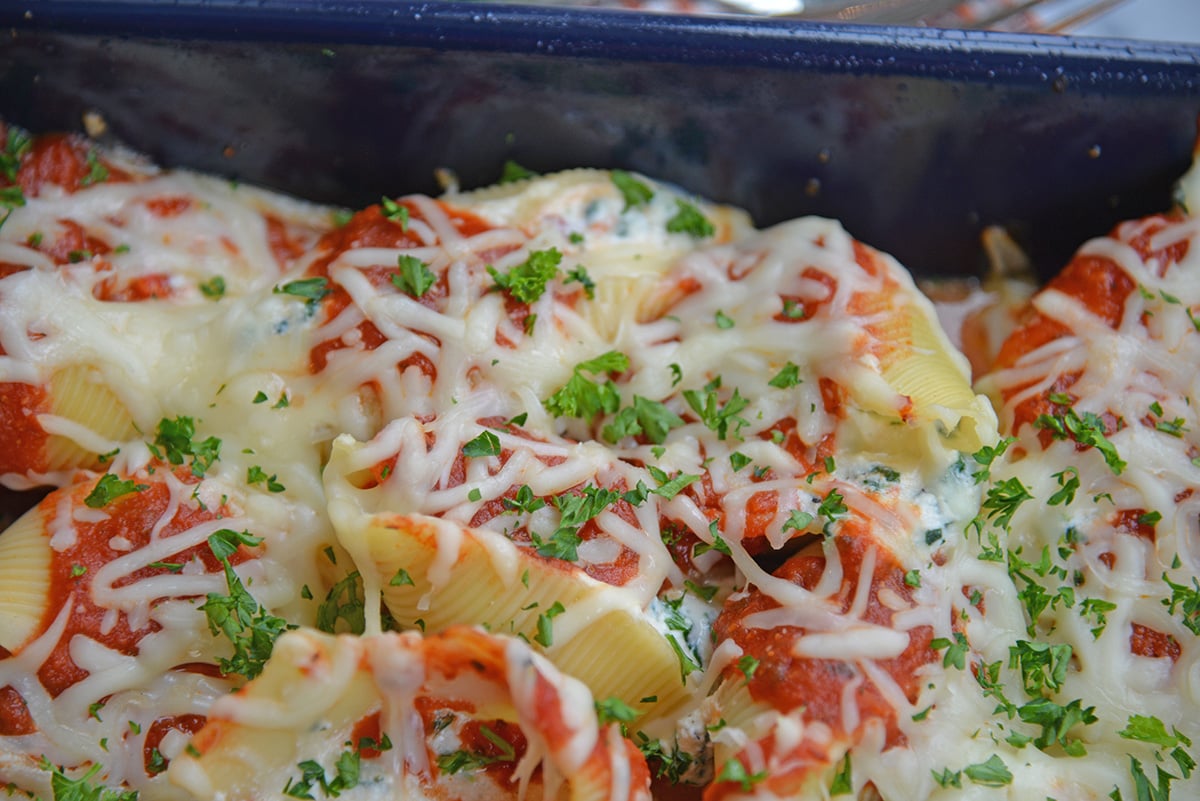 close up angled shot of baked spinach stuffed shells