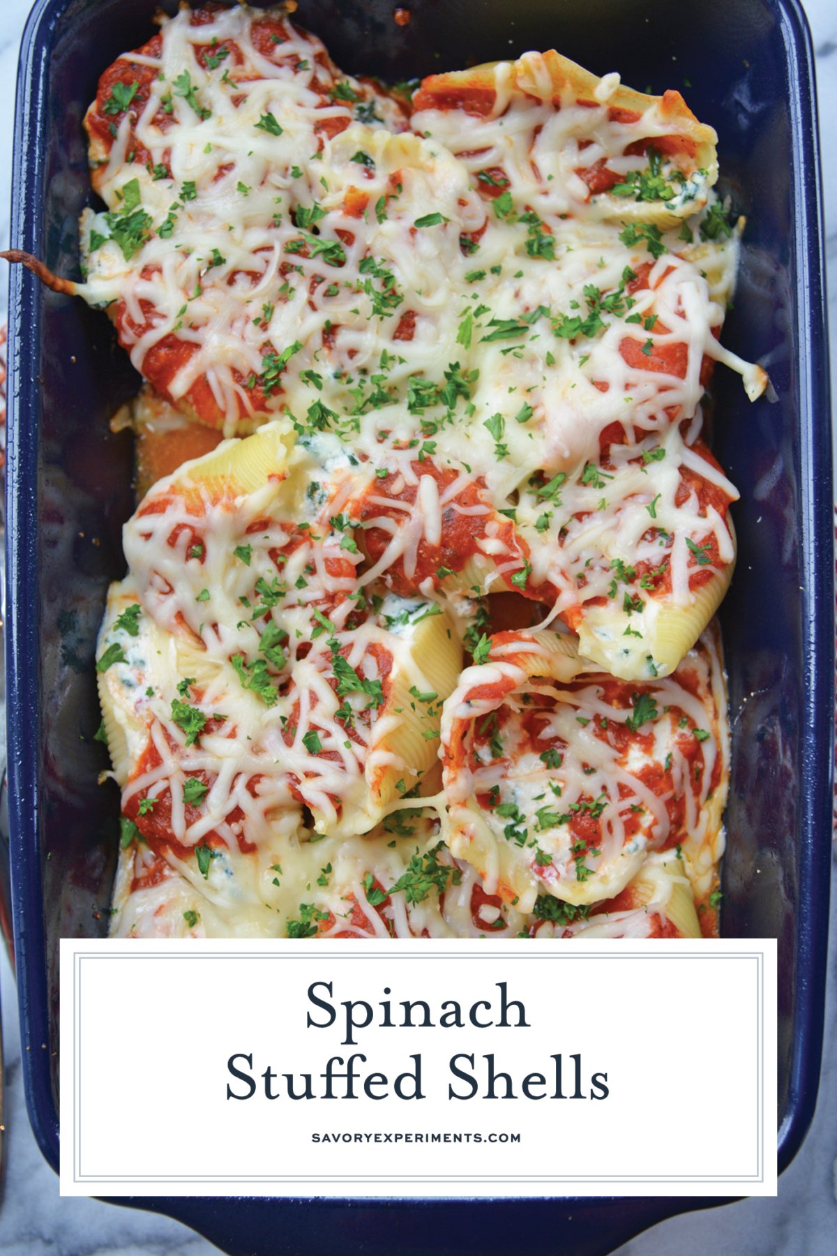 overhead shot of baking dish of spinach stuffed shells with text overlay