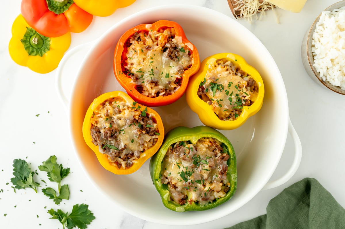 overhead shot of four classic stuffed peppers in dish