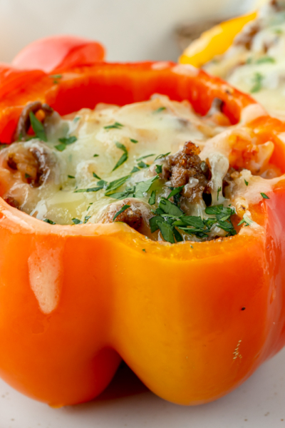 angled shot of red stuffed pepper on plate