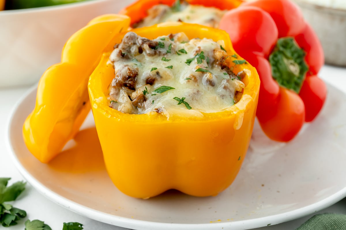 angled shot of yellow classic stuffed pepper on plate