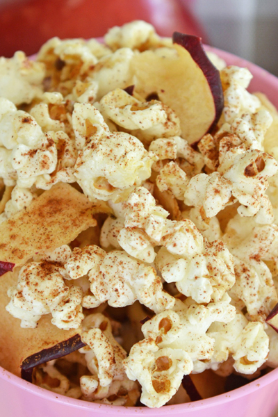 close up angled shot of bucket of apple cinnamon popcorn