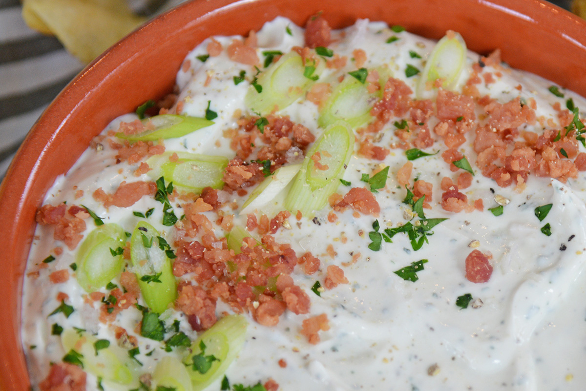 close up angled shot of bowl of bacon ranch dip