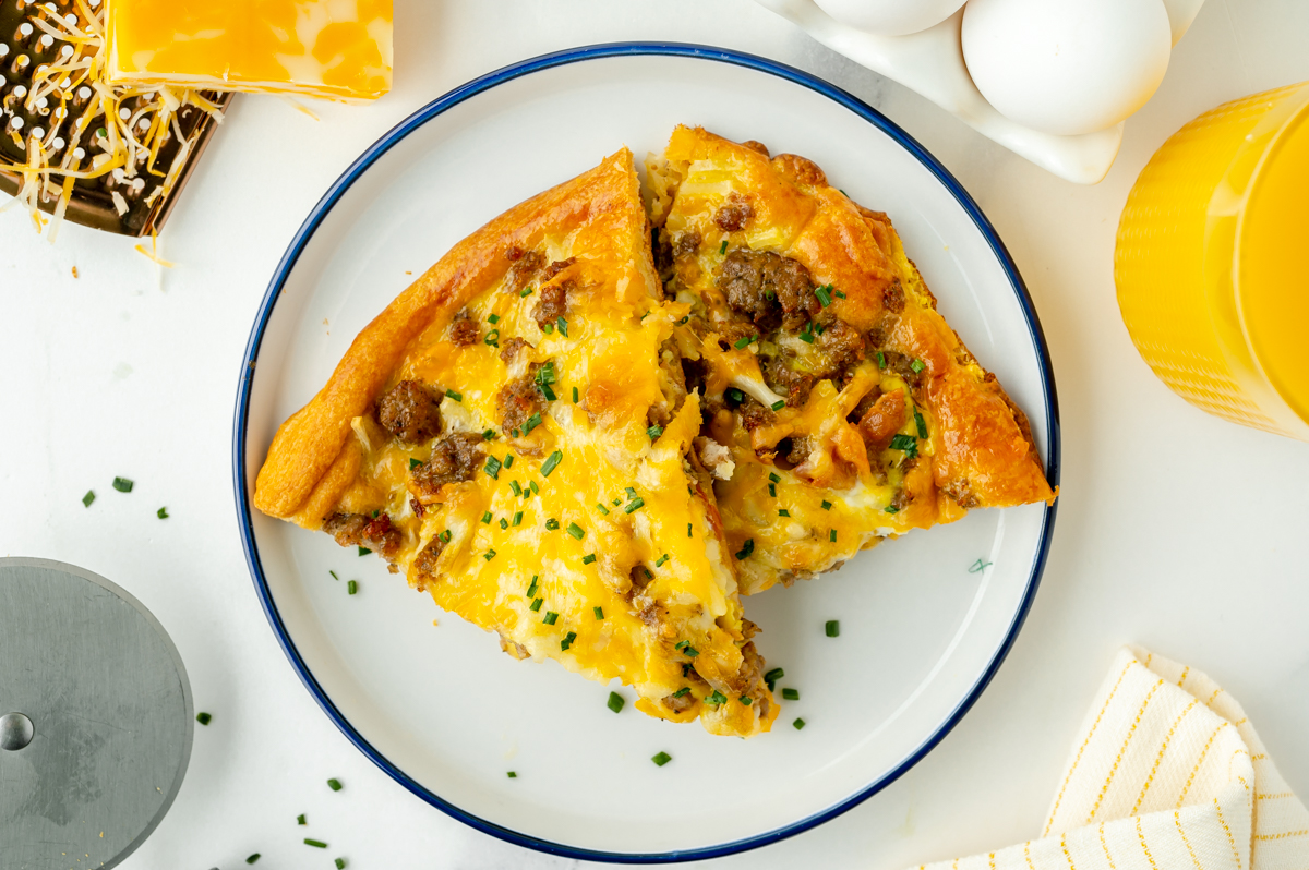 overhead shot of two overlapping slices of breakfast pizza on a plate