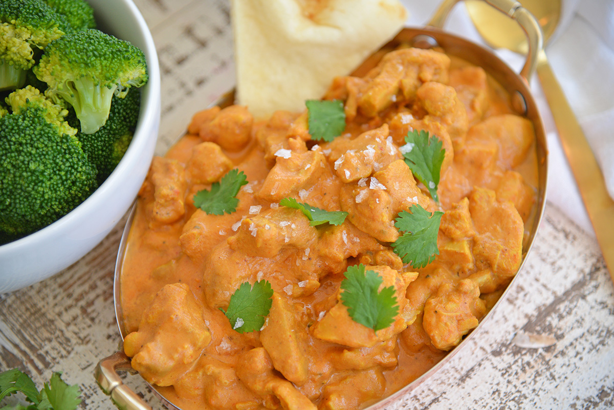 close up angled shot of dish of butter chicken