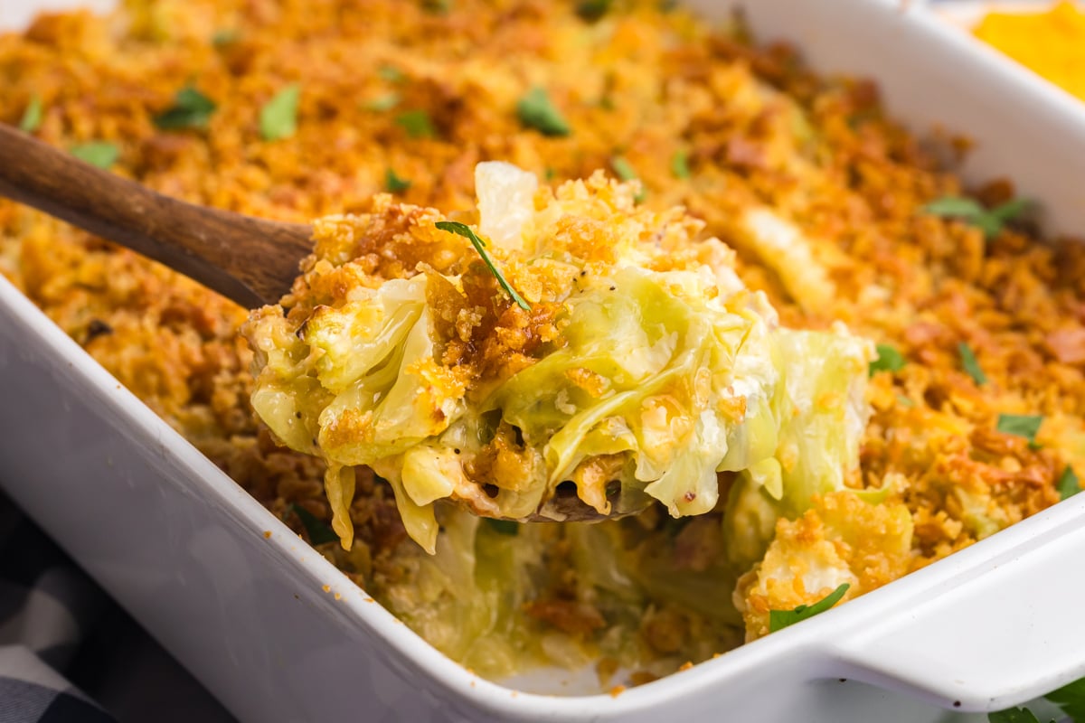 wooden spoon taking scoop out of cabbage casserole