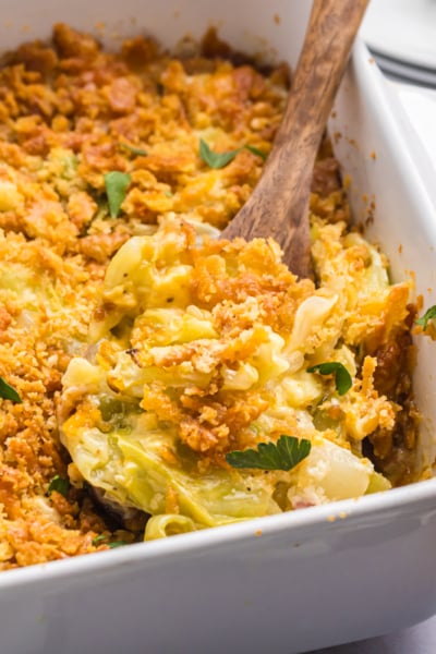 angled shot of wooden spoon in cabbage casserole