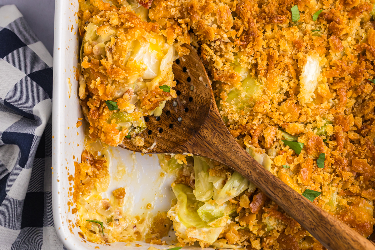 overhead shot of wooden spoon in cabbage casserole