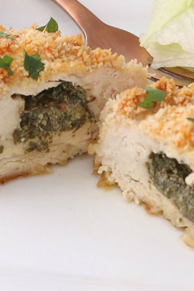 close up of chicken kiev cut in half on plate