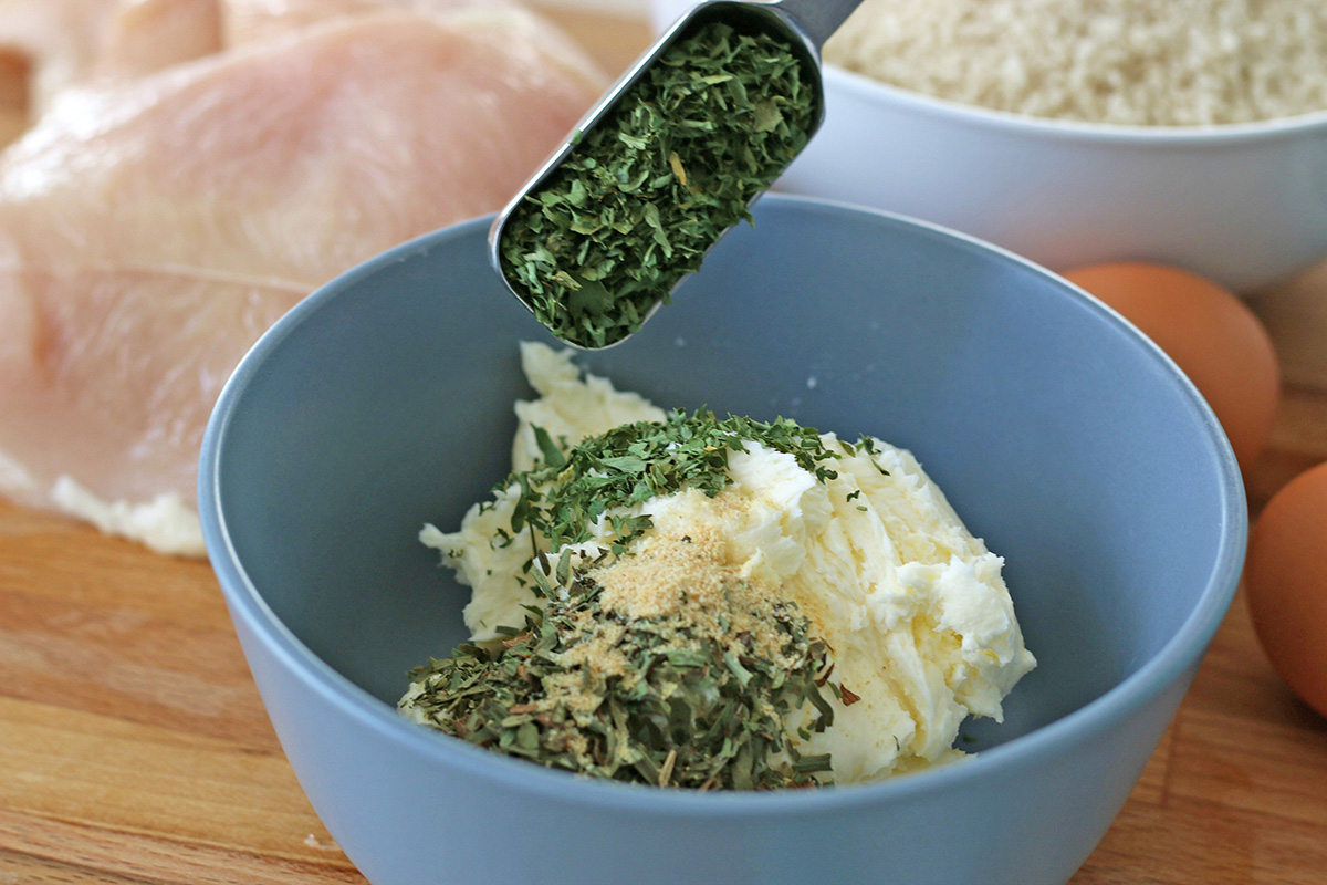 Dried herbs in butter in a bowl mixing bowl