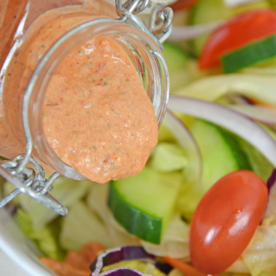 dressing pouring onto salad