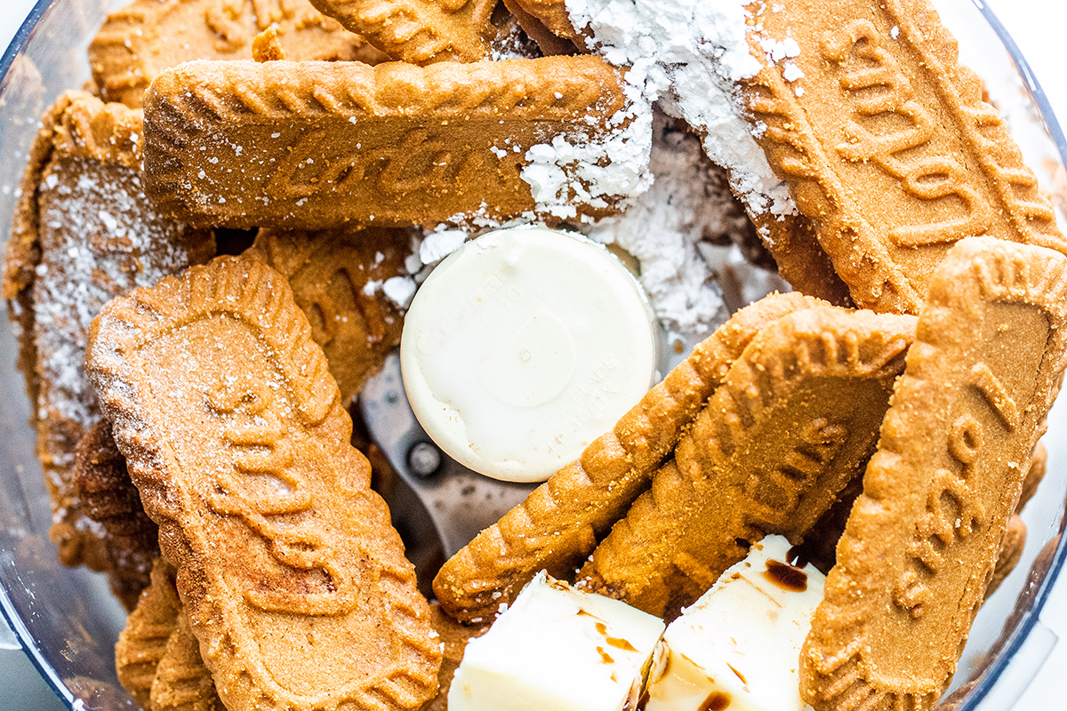 overhead shot of cookies, butter and powdered sugar in food processor