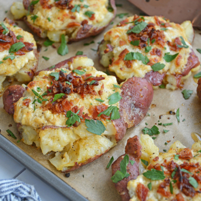 angled shot of crab smashed potatoes on baking sheet