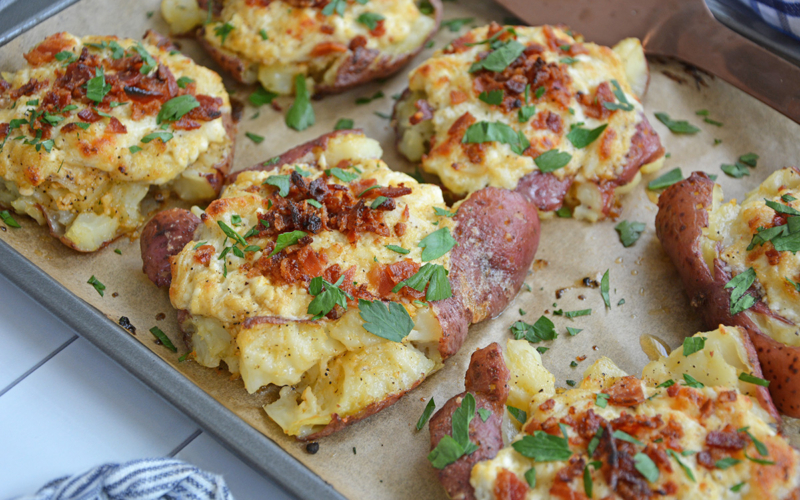 angled shot of crab smashed potatoes on baking sheet