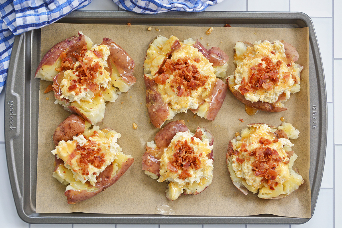 overhead shot of crab smashed potatoes on baking sheet before baking