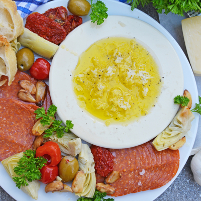 overhead shot of plate of meats and bread dip