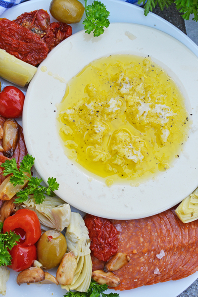 overhead shot of plate of meats and bread dip