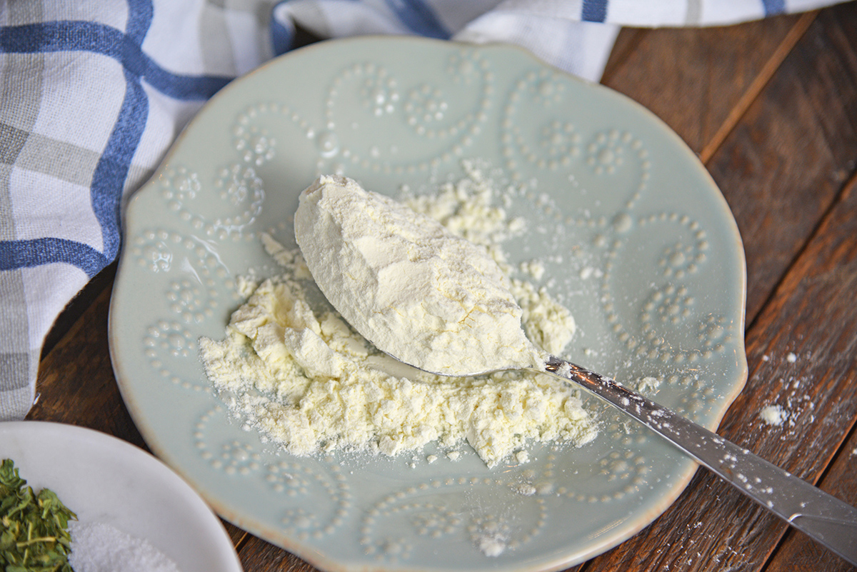 angled shot of spoon of dried buttermilk on plate