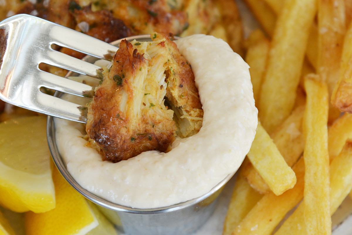 close up of lump crab meat dipping into horseradish sauce