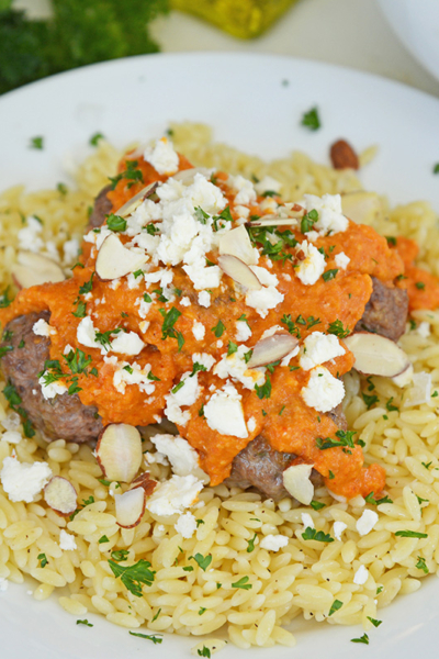 angled shot of plate of orzo and lamb meatballs