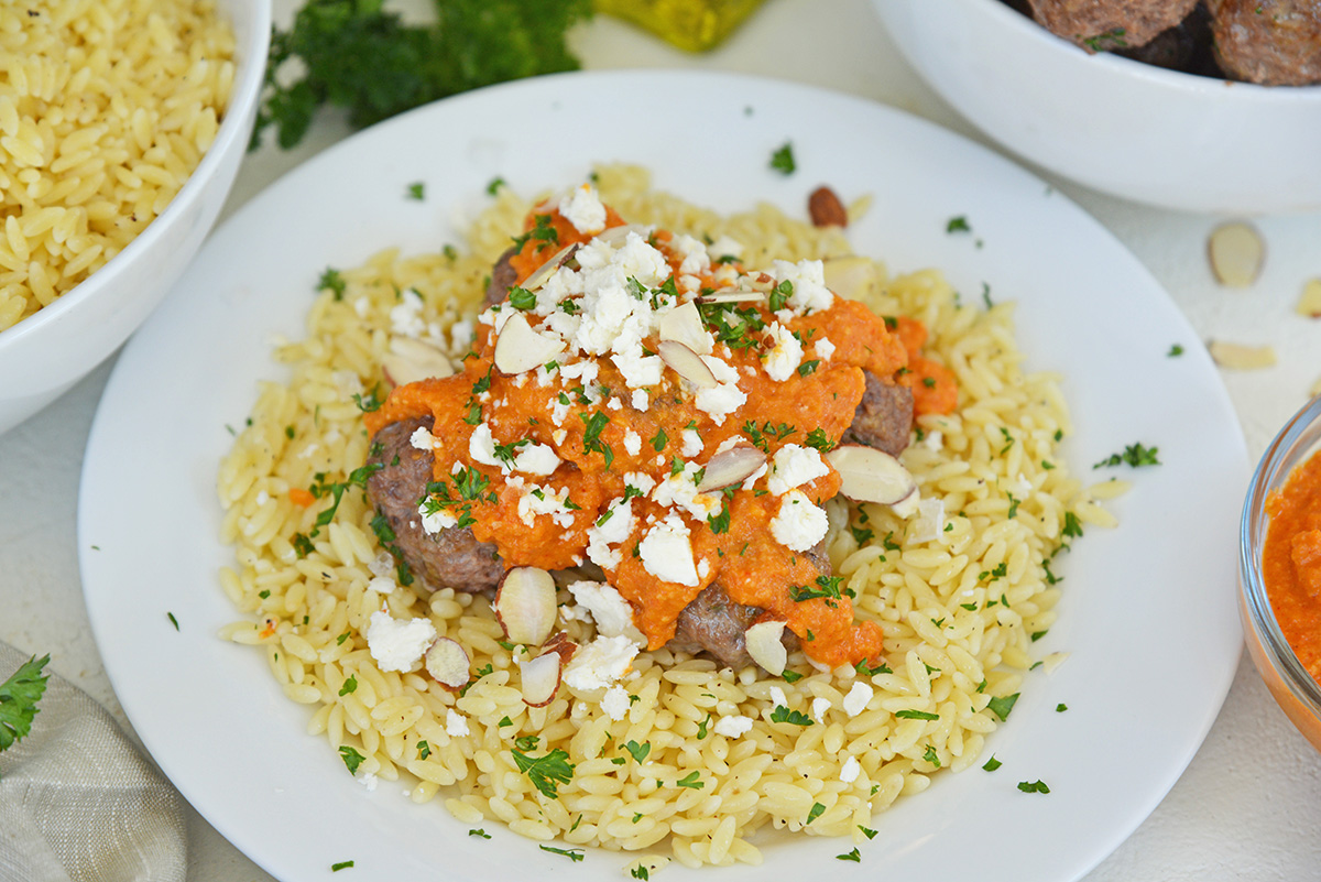 angled shot of plate of orzo and lamb meatballs