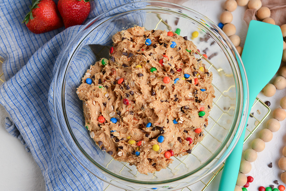 overhead shot of monster cookie dip in mixing bowl