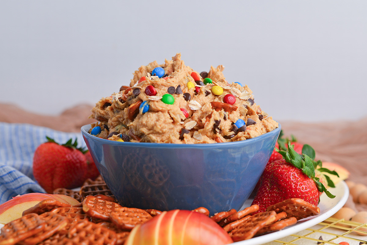 straight on shot of monster cookie dip in blue bowl