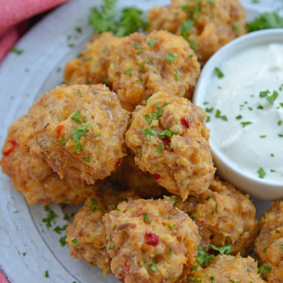 close up angled shot of plate of pimento cheese sausage balls